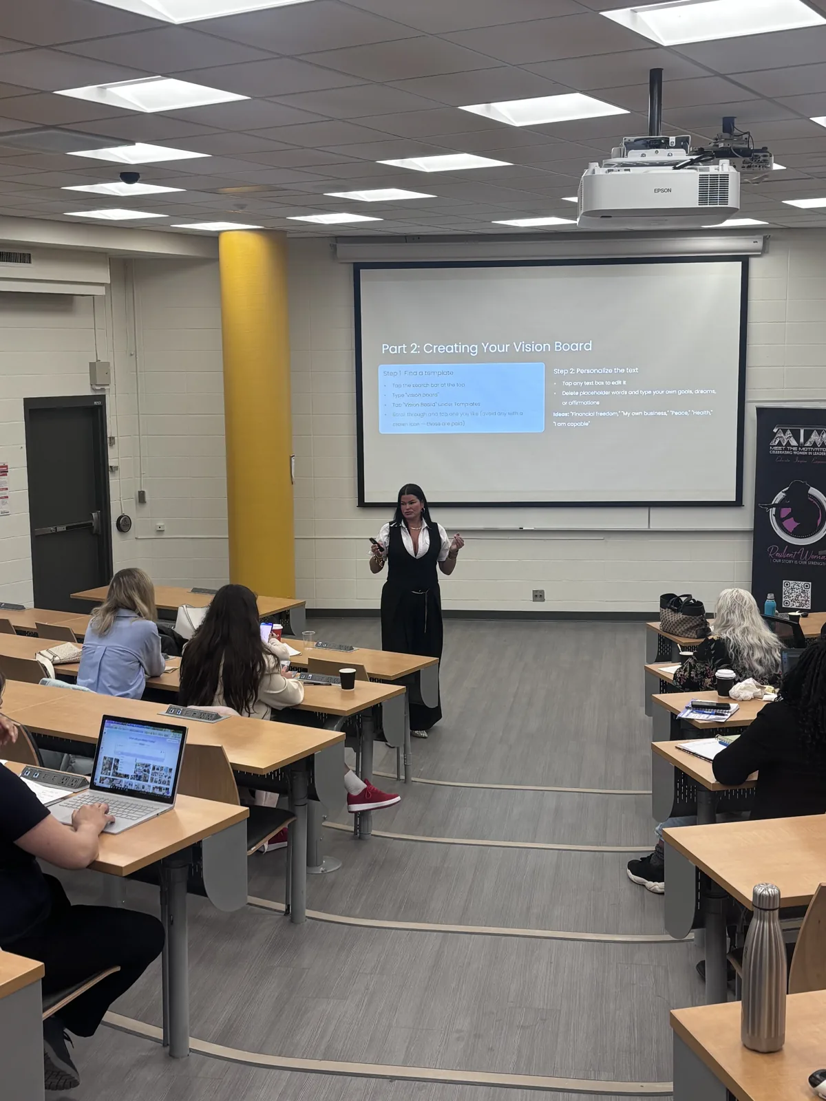 Women participating in a TecHer Forward workshop while Tara presents from the front of the room.